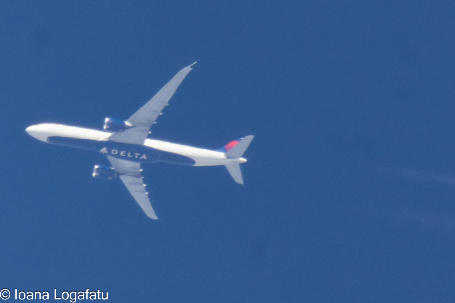 High above the clouds, a plane glides gracefully